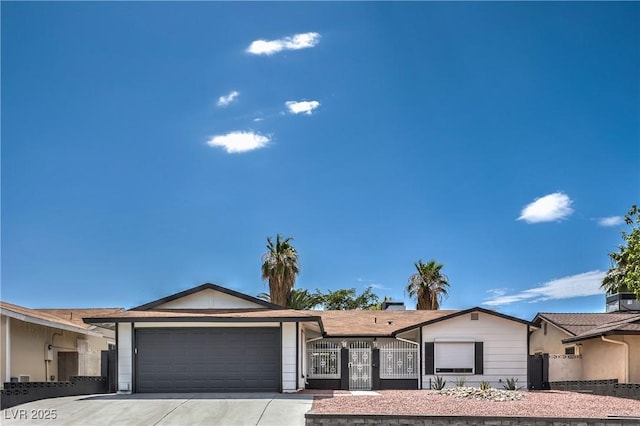 4277 Rimcrest Rd, Las Vegas, NV 89121 - ranch-style house with an attached garage, driveway, and a gate