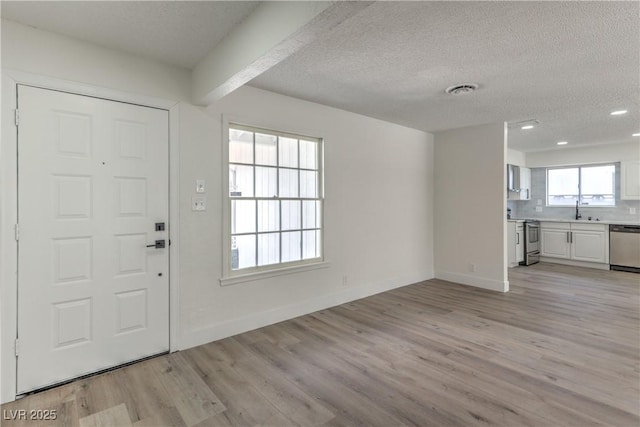 4277 Rimcrest Rd, Las Vegas, NV 89121 - foyer featuring light wood-type flooring, a textured ceiling, and recessed lighting