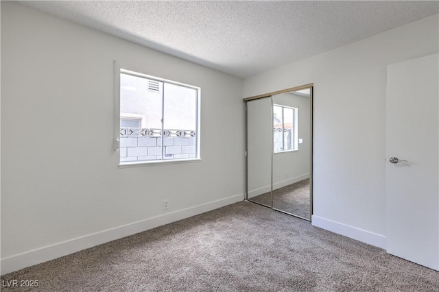 4277 Rimcrest Rd, Las Vegas, NV 89121 - unfurnished bedroom featuring carpet flooring, a textured ceiling, and a closet