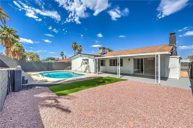 4277 Rimcrest Rd, Las Vegas, NV 89121 - rear view of property featuring a fenced backyard, a patio, and a chimney