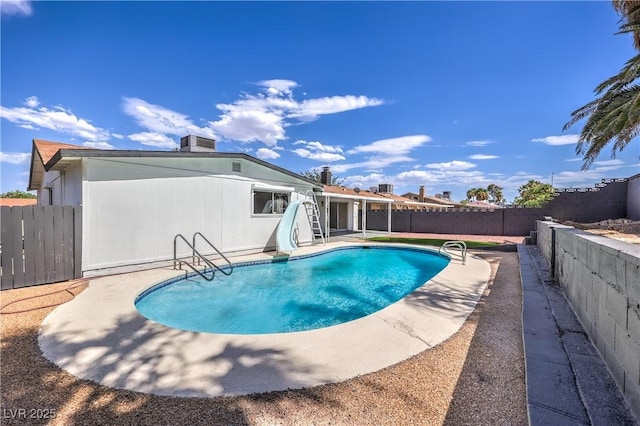 4277 Rimcrest Rd, Las Vegas, NV 89121 - view of swimming pool with a water slide, a fenced backyard, and a patio area