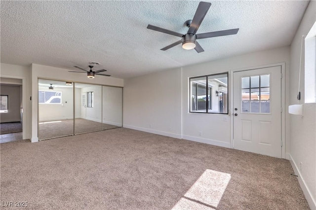 4277 Rimcrest Rd, Las Vegas, NV 89121 - unfurnished living room featuring ceiling fan, a textured ceiling, carpet flooring, and plenty of natural light