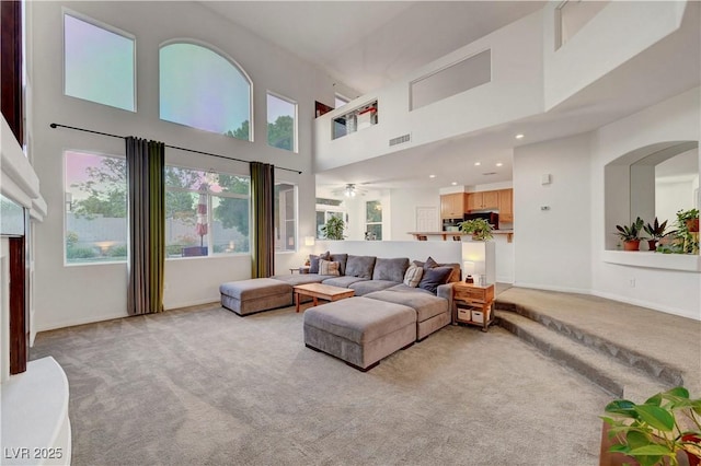 8812 Glenistar Gate Ave, Las Vegas, NV 89143 - living room featuring light carpet, a high ceiling, and recessed lighting