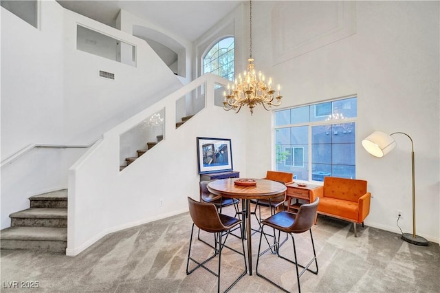 8812 Glenistar Gate Ave, Las Vegas, NV 89143 - dining space with stairs, carpet, a towering ceiling, and a chandelier