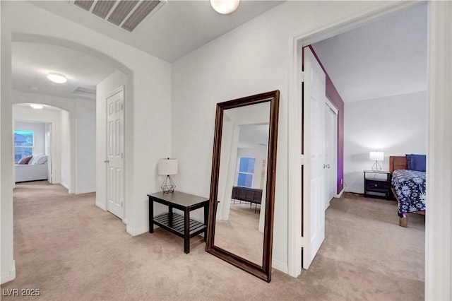 8812 Glenistar Gate Ave, Las Vegas, NV 89143 - corridor with light colored carpet and arched walkways