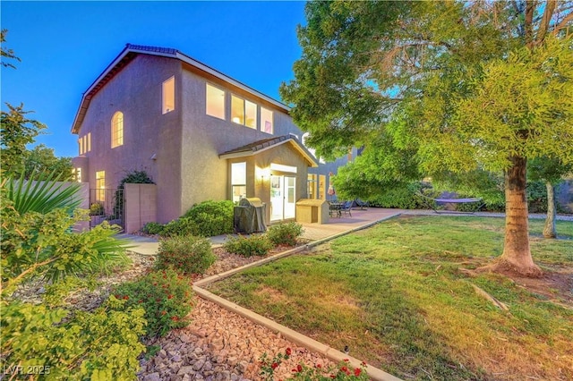 8812 Glenistar Gate Ave, Las Vegas, NV 89143 - rear view of house featuring stucco siding and a patio area
