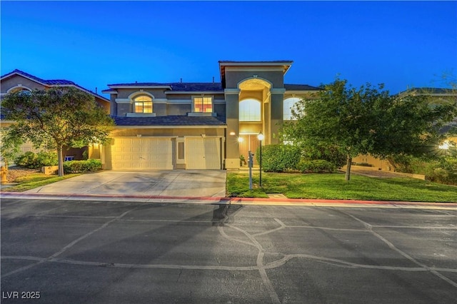 8812 Glenistar Gate Ave, Las Vegas, NV 89143 - view of front of house featuring stucco siding, an attached garage, driveway, and a front lawn
