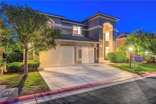 8812 Glenistar Gate Ave, Las Vegas, NV 89143 - view of front of property featuring an attached garage, driveway, and stucco siding