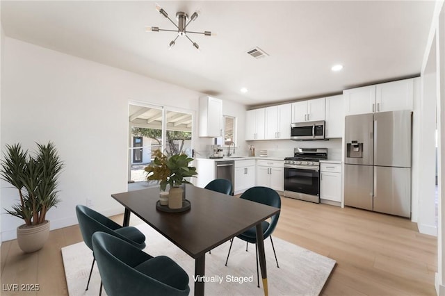 1700 Sweeney Ave, Las Vegas, NV 89104 - dining area featuring light wood-style floors, recessed lighting, and a chandelier