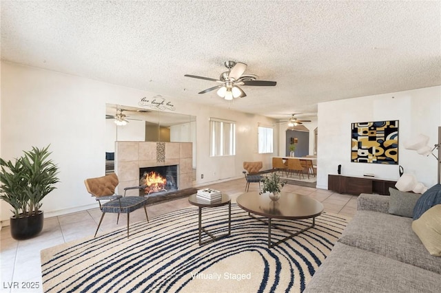 5809 Pebble Beach Blvd, Las Vegas, NV 89108 - tiled living area featuring a ceiling fan, a fireplace, and a textured ceiling