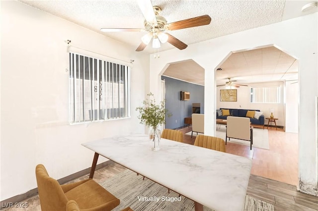 5809 Pebble Beach Blvd, Las Vegas, NV 89108 - dining space featuring ceiling fan, wood finished floors, a textured ceiling, and arched walkways