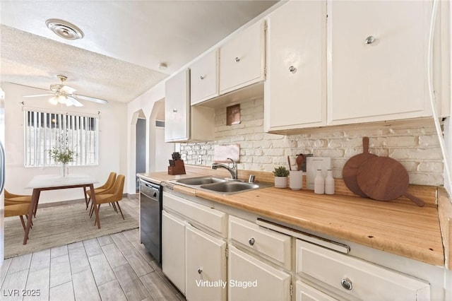 5809 Pebble Beach Blvd, Las Vegas, NV 89108 - kitchen with dishwashing machine, decorative backsplash, light countertops, arched walkways, and a ceiling fan