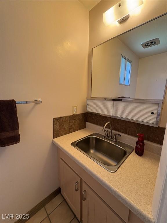 1133 Bell Ave, Ely, NV 89301 - bathroom with vanity, tile patterned flooring, and decorative backsplash