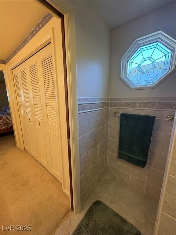 1133 Bell Ave, Ely, NV 89301 - bathroom featuring tile walls, tile patterned floors, and a closet