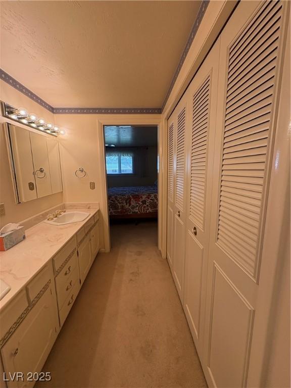1133 Bell Ave, Ely, NV 89301 - ensuite bathroom featuring a closet, double vanity, and crown molding