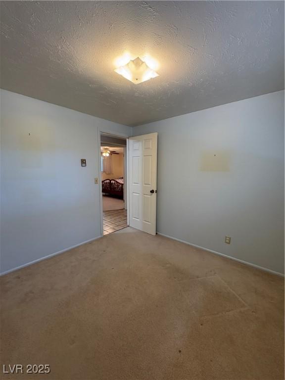 1133 Bell Ave, Ely, NV 89301 - empty room featuring a textured ceiling and light colored carpet