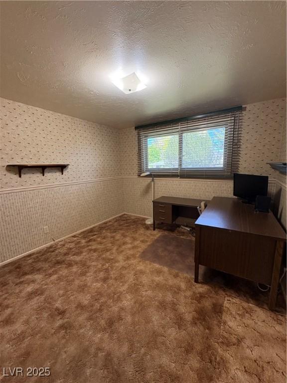 1133 Bell Ave, Ely, NV 89301 - office area featuring wallpapered walls, carpet, and a textured ceiling
