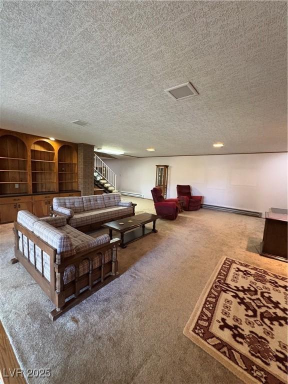 1133 Bell Ave, Ely, NV 89301 - carpeted living room with a textured ceiling and a baseboard heating unit