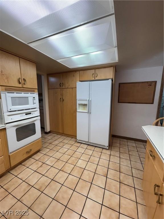 1133 Bell Ave, Ely, NV 89301 - kitchen featuring white appliances, light countertops, and light tile patterned floors