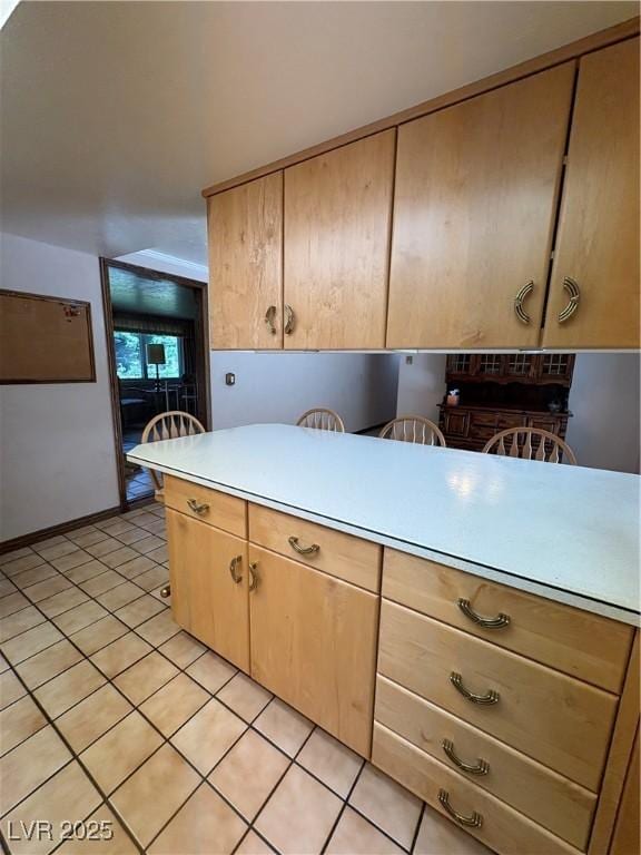 1133 Bell Ave, Ely, NV 89301 - kitchen featuring light tile patterned floors, light countertops, and light brown cabinets