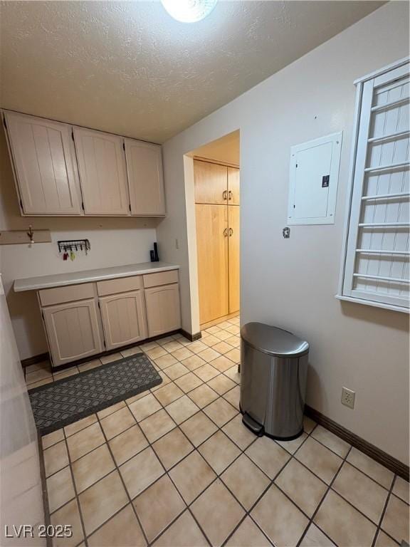 1133 Bell Ave, Ely, NV 89301 - kitchen featuring electric panel, a textured ceiling, light countertops, and light tile patterned flooring