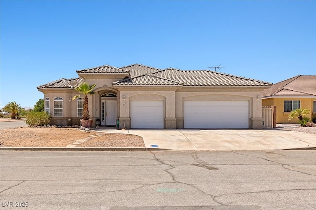 467 Muddy Peak Ct, Overton, NV 89040 - mediterranean / spanish home with an attached garage, concrete driveway, stucco siding, and a tiled roof