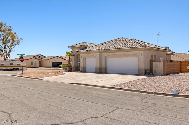 467 Muddy Peak Ct, Overton, NV 89040 - mediterranean / spanish house featuring an attached garage, stucco siding, a tile roof, and driveway