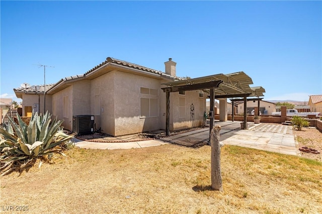 467 Muddy Peak Ct, Overton, NV 89040 - rear view of house featuring a chimney, a pergola, a tiled roof, a patio, and stucco siding