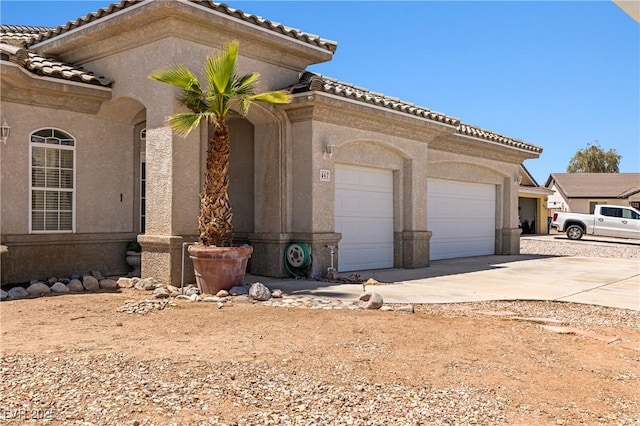 467 Muddy Peak Ct, Overton, NV 89040 - view of front of property with a garage, concrete driveway, a tile roof, and stucco siding