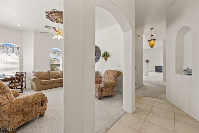 467 Muddy Peak Ct, Overton, NV 89040 - hallway featuring light colored carpet, arched walkways, a towering ceiling, light tile patterned floors, and recessed lighting