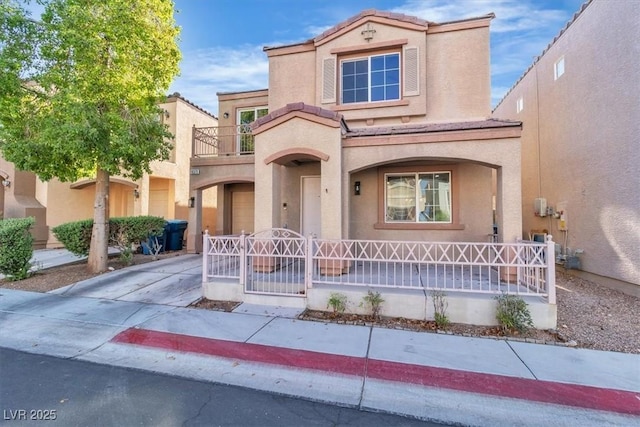 10373 Midnight Iris St, Las Vegas, NV 89183 - view of front of house with covered porch, stucco siding, and a balcony