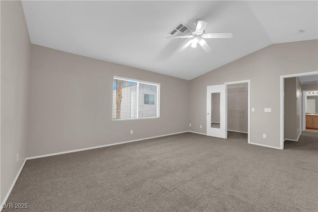 1553 Ivygate Ave, Las Vegas, NV 89183 - unfurnished bedroom featuring vaulted ceiling, carpet, a walk in closet, a ceiling fan, and a closet