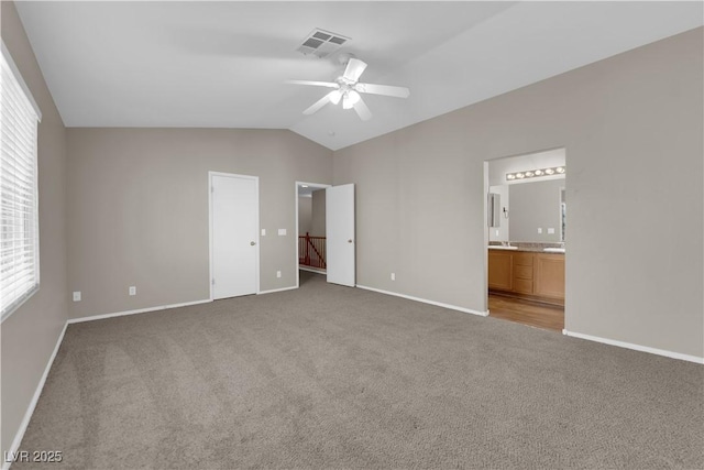 1553 Ivygate Ave, Las Vegas, NV 89183 - unfurnished bedroom featuring carpet flooring, vaulted ceiling, ensuite bathroom, and ceiling fan