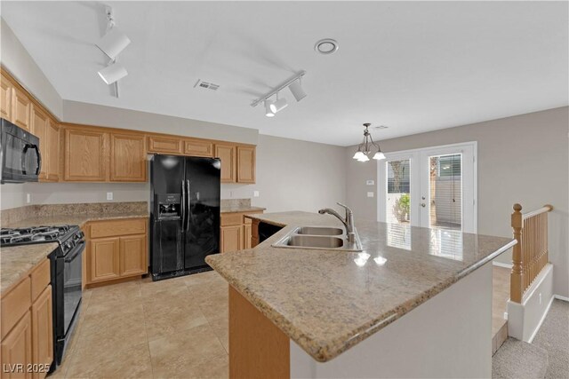 1553 Ivygate Ave, Las Vegas, NV 89183 - kitchen with black appliances, track lighting, french doors, a kitchen island with sink, and hanging light fixtures