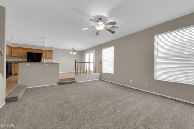 1553 Ivygate Ave, Las Vegas, NV 89183 - unfurnished living room with a ceiling fan, light carpet, and a chandelier