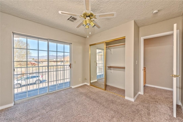 1201 Bourbon St, Pahrump, NV 89048 - unfurnished bedroom with access to outside, carpet, a closet, a textured ceiling, and a ceiling fan