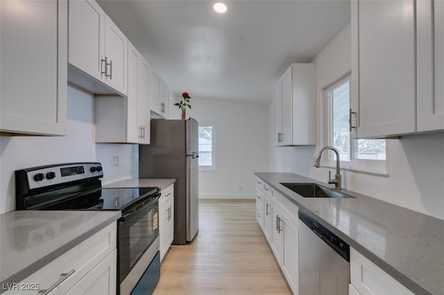 709 N 22nd St, Las Vegas, NV 89101 - kitchen with stainless steel appliances, healthy amount of natural light, light wood-type flooring, and light stone countertops
