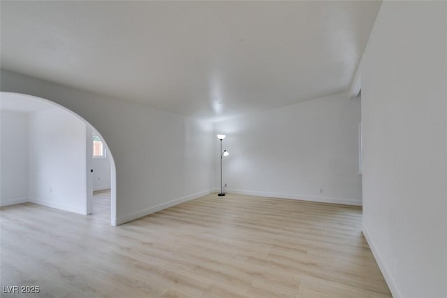 709 N 22nd St, Las Vegas, NV 89101 - empty room with arched walkways and light wood-style floors