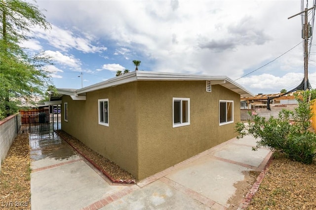 709 N 22nd St, Las Vegas, NV 89101 - view of side of property with stucco siding, a fenced backyard, and a patio