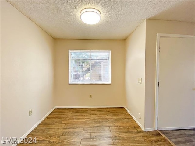 2705 Jennydiane Dr, Las Vegas, NV 89121 - spare room featuring a textured ceiling and wood finished floors