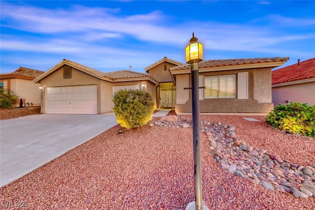 1643 Silver Slipper Ave, Henderson, NV 89002 - view of front of home featuring stucco siding, concrete driveway, an attached garage, and a tile roof