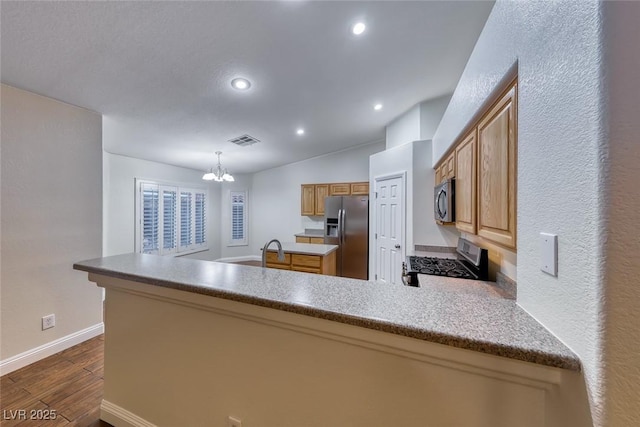 1643 Silver Slipper Ave, Henderson, NV 89002 - kitchen featuring stainless steel appliances, dark wood-style flooring, a chandelier, a peninsula, and recessed lighting