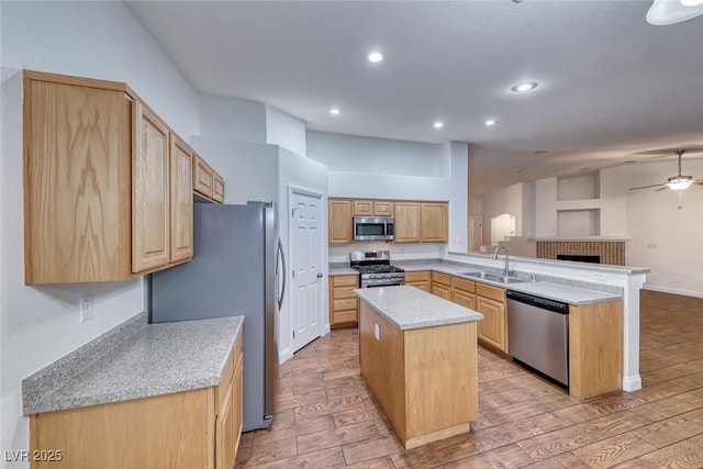 1643 Silver Slipper Ave, Henderson, NV 89002 - kitchen featuring appliances with stainless steel finishes, a peninsula, a ceiling fan, light wood-style floors, and recessed lighting
