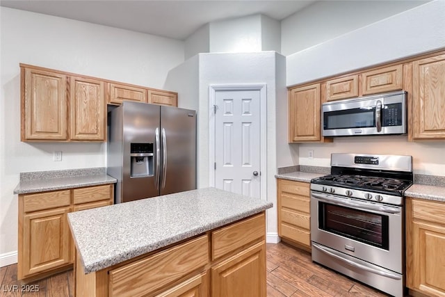 1643 Silver Slipper Ave, Henderson, NV 89002 - kitchen with stainless steel appliances, light wood-style flooring, and light brown cabinets
