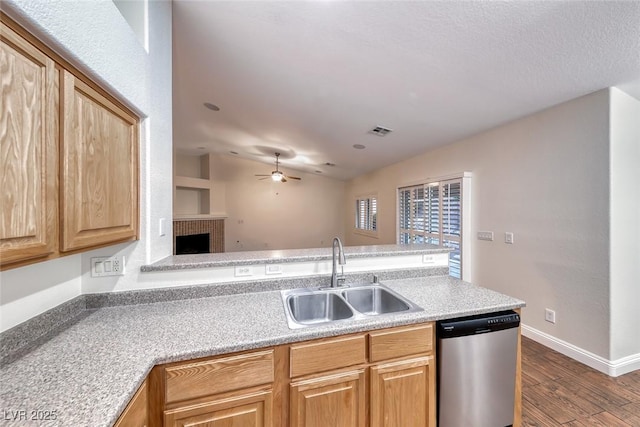 1643 Silver Slipper Ave, Henderson, NV 89002 - kitchen with dishwasher, wood finished floors, a ceiling fan, light countertops, and a fireplace