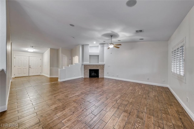 1643 Silver Slipper Ave, Henderson, NV 89002 - unfurnished living room featuring a ceiling fan, wood finished floors, and a fireplace