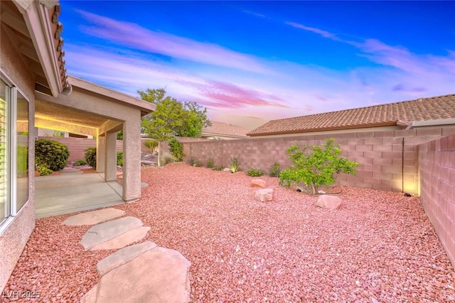 1643 Silver Slipper Ave, Henderson, NV 89002 - yard at dusk featuring a fenced backyard and a patio area