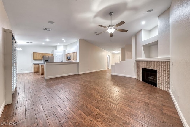 1643 Silver Slipper Ave, Henderson, NV 89002 - unfurnished living room with ceiling fan, dark wood-style flooring, a fireplace, and recessed lighting