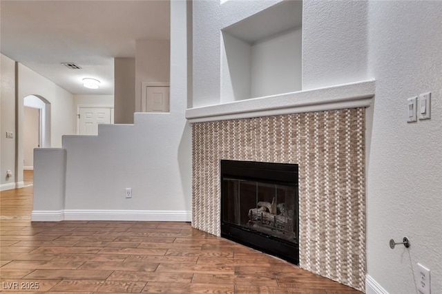 1643 Silver Slipper Ave, Henderson, NV 89002 - detailed view of wood finished floors, a tile fireplace, and a textured wall