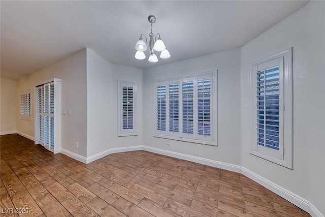 1643 Silver Slipper Ave, Henderson, NV 89002 - empty room featuring a chandelier and wood finished floors